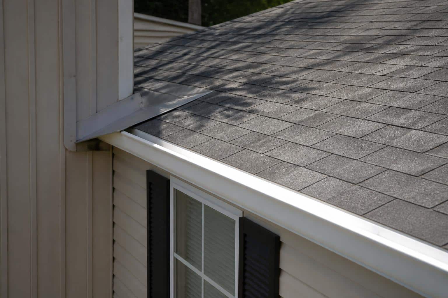 Close view of intact roof shingles, flashing, and roof edge on a Florida manufactured home